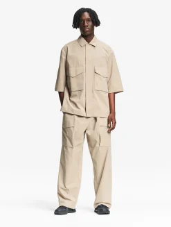 Le pantalon mixte ample Aigle Experience by Études - Beige
